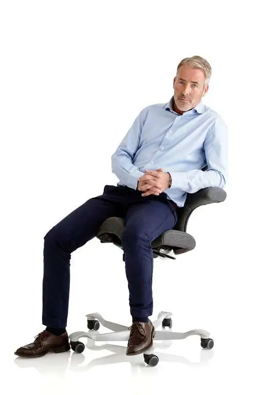 man-sitting-on-capisco